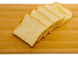 Side view of slices of toast bread on breadboard wooden, isolated on white background.