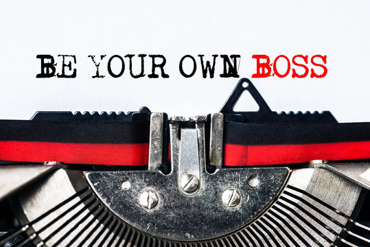 be your own boss typed on white paper with old typewriter
