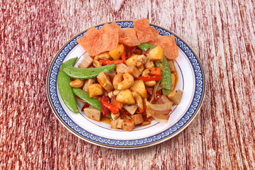 Fried mixed fruit and vegetable with roasted chili plate .