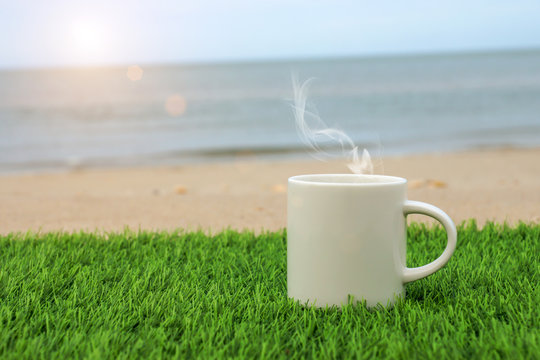 White coffee mug on the beach