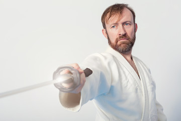 A man with katana on white background on Iaido practice