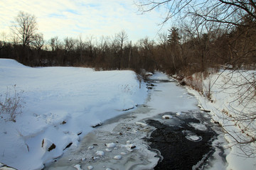 Winter landscape with frozen creek