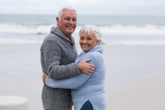 Senior couple standing together on the beach