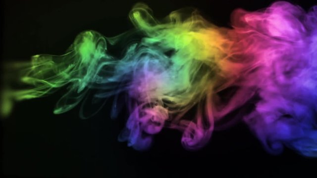 A plume of rainbow colored smoke moves from right to left, creating a psychedelic path of haze..