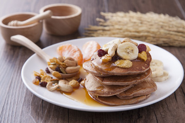 Sweet pancake with banana and serial topping on the white dish