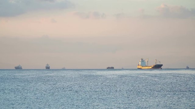 Cargo ships in the Bay of Manila. Large container ship in the sea, blue sky and clouds. 4K video. Philippines, Manila.