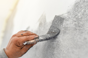 hand of worker use brush for color paint concrete Loft style on wall
