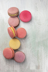 Pastel colored macarons on light teal texture