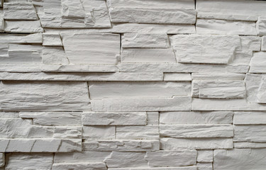 A fragment of a decorative wall made of artificial stone.