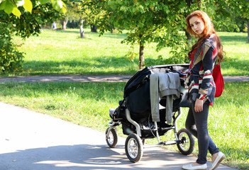 Fototapeta na wymiar women walk stroller summer