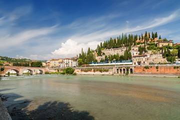 Sunny view of Adige river and Stone Bridge (Ponte di Pietra) in Verona, Veneto region, Italy.