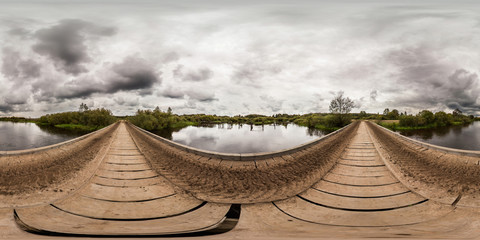 Full 360 degree equirectangula panorama wooden bridge over the river