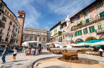 Sunny view of the Piazza delle Erbe, palazzo Maffei and Gardello tower at historical center of...