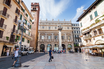 Fototapeta na wymiar Sunny view of the Piazza delle Erbe, palazzo Maffei and Gardello tower at historical center of Verona, Veneto region, Italy.