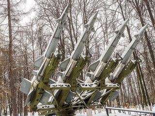 Anti-aircraft missiles bombarded day with snow in the park in winter.
