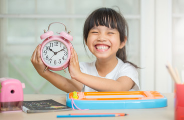 childhood and education concept - happy student girl preparing for school exams