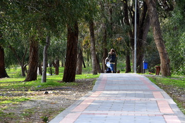 woman with stroller walking in Dasoudi park, Limassol, Cyprus