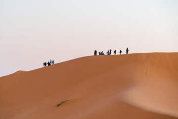 Naklejka premium Sahara Desert , tourist Climbing 
