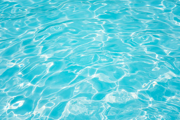 Fototapeta na wymiar Blue water surface and ripple wave in swimming pool for background