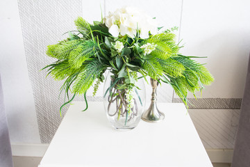 Decoration artificial flower in jar on wood table