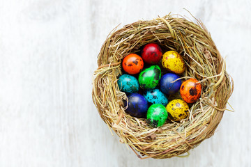 A nest with colored Easter eggs at home on Easter day