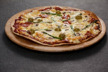 Delicious italian pizza served on wooden board