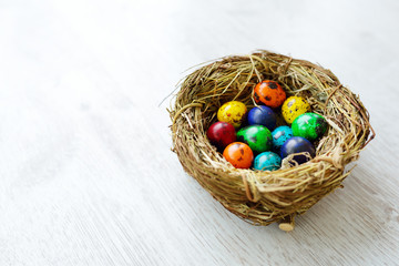 A nest with colored Easter eggs at home on Easter day