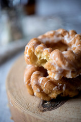 Sweet donuts with icing on wooden background