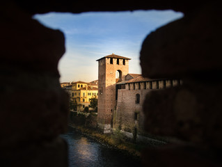 Obraz premium View through hole in wall on old tower in Verona, Italy - Sneak Peek