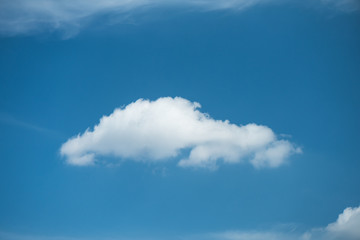 Naklejka na ściany i meble Single white cloud on blue sky