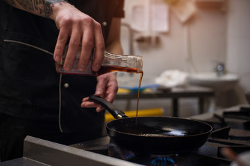 Closeup of male chef working in restaraunt kitchen