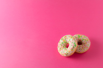 Two donuts on pink background