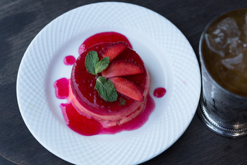 Delicious Strawberry Custard on a white plate and wooden background 