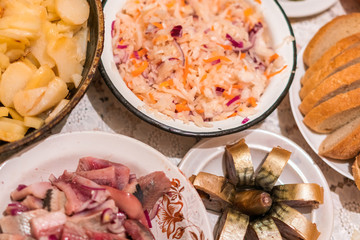 Country dinner with roast potatoes, smoked fish, bread and coleslaw