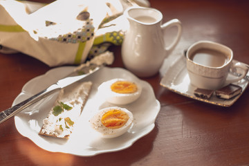 Breakfast: boiled egg, crisp with cream cheese and coffee with milk