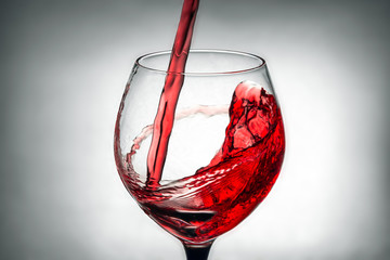 red wine pouring splash into glass