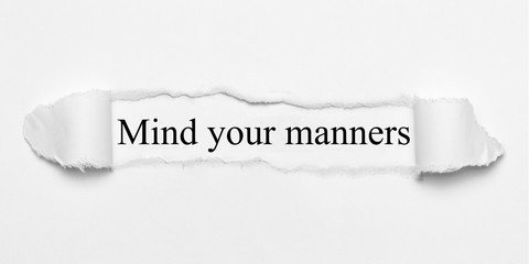 Mind your manners on white torn paper