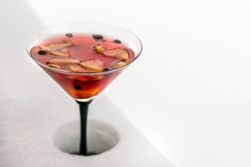 Glass of mulled wine on snow
