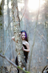 Portrait of the gothic woman in the dark winter forest 