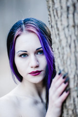 Fototapeta premium Close-up portrait of the gothic woman in the dark winter forest 