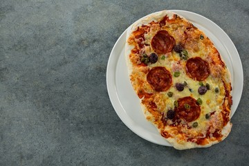 Italian pepperoni pizza served on a pizza tray