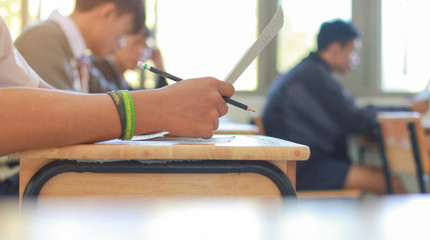 students writing test exam on paper for Admissions in high schoo