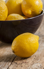 Lemon on old wooden background. Shallow depth of field, toned photo.