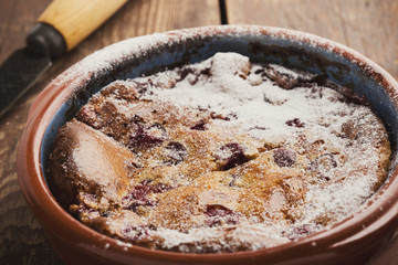 Classic french dessert cherry clafoutis in ceramic bowl