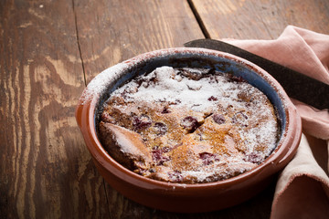 Classic french dessert cherry clafoutis in ceramic bowl