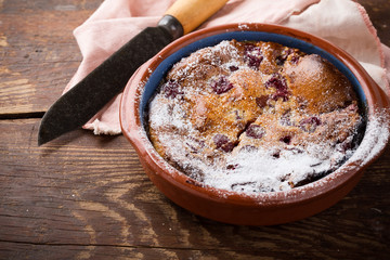 Classic french dessert cherry clafoutis in ceramic bowl