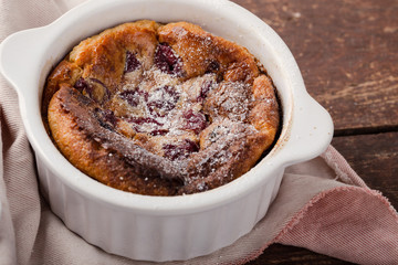 French dessert cherry clafoutis in ceramic ramekins