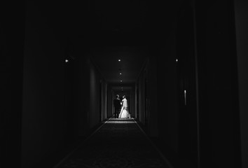 married couple go  narrow corridor