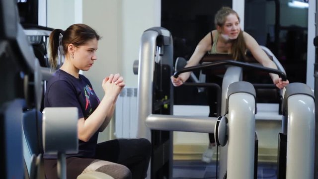 attractive woman works out on leg press machine at the gym