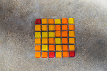 Concrete with red and yellow textured tile.